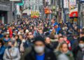 COLOGNE, GERMANY - FEBRUARY 19: People walk on a pedestrian shopping street in the city center during the Omicron wave of the novel coronavirus variant on February 19, 2022 in Cologne, Germany. Omicron infections have peaked in Germany, and given the relatively low rate of Covid hospitalizations both federal and state authorities have begun phasing out many coronavirus-related restrictions. As of today, people in the state of North Rhine-Westphalia no longer need to show proof of vaccination in order to enter non-essential stores, though wearing a protective face mask is still required. (Photo by Sascha Schuermann/Getty Images)